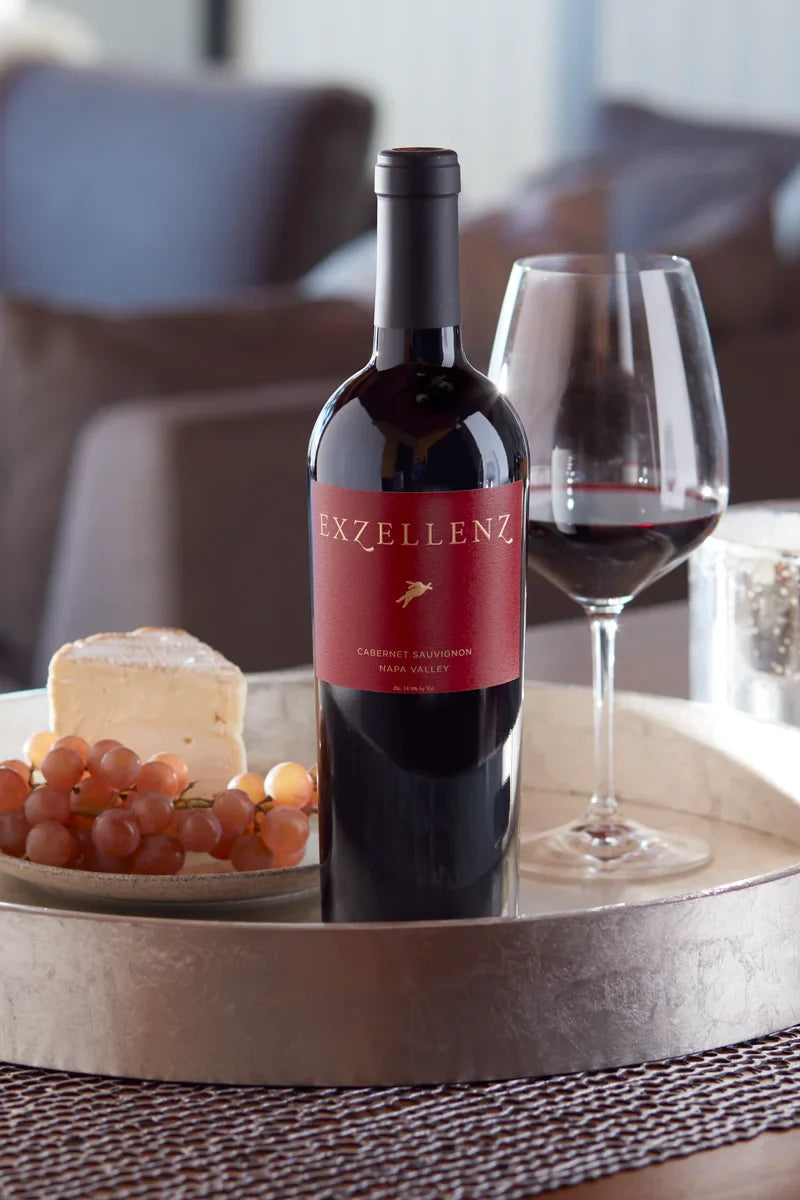 2021 HALL Exzellenz Cabernet Sauvignon on tray with cheese, fruit, and glass of red wine