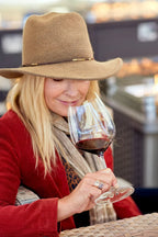 Woman smelling glass of red wine featuring 2017 HALL Exzellenz Cabernet Sauvignon