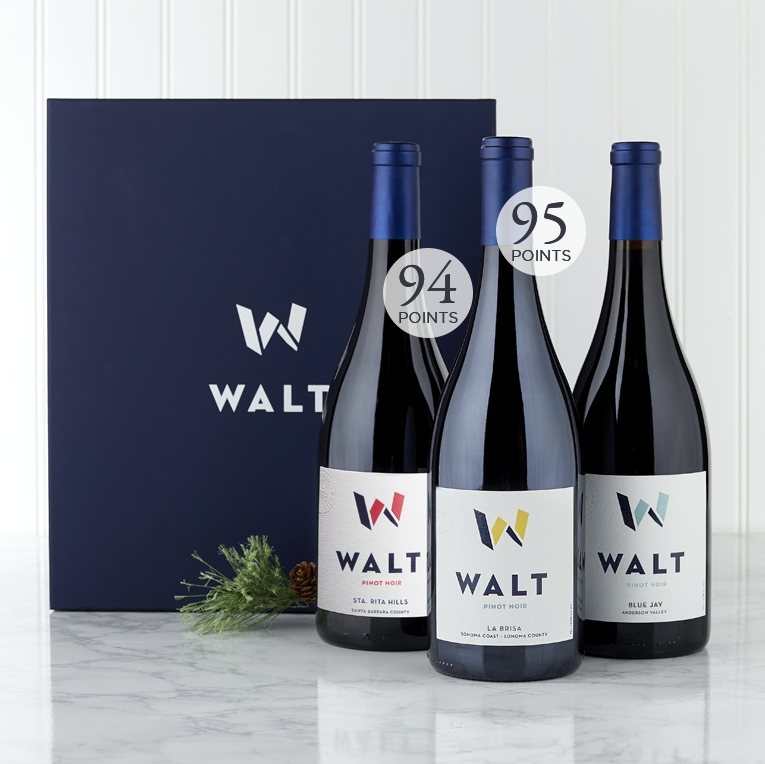 Image of WALT Appellation Trio Gift Set featuring 3 bottles of WALT Pinot Noir and a blue gift box. 